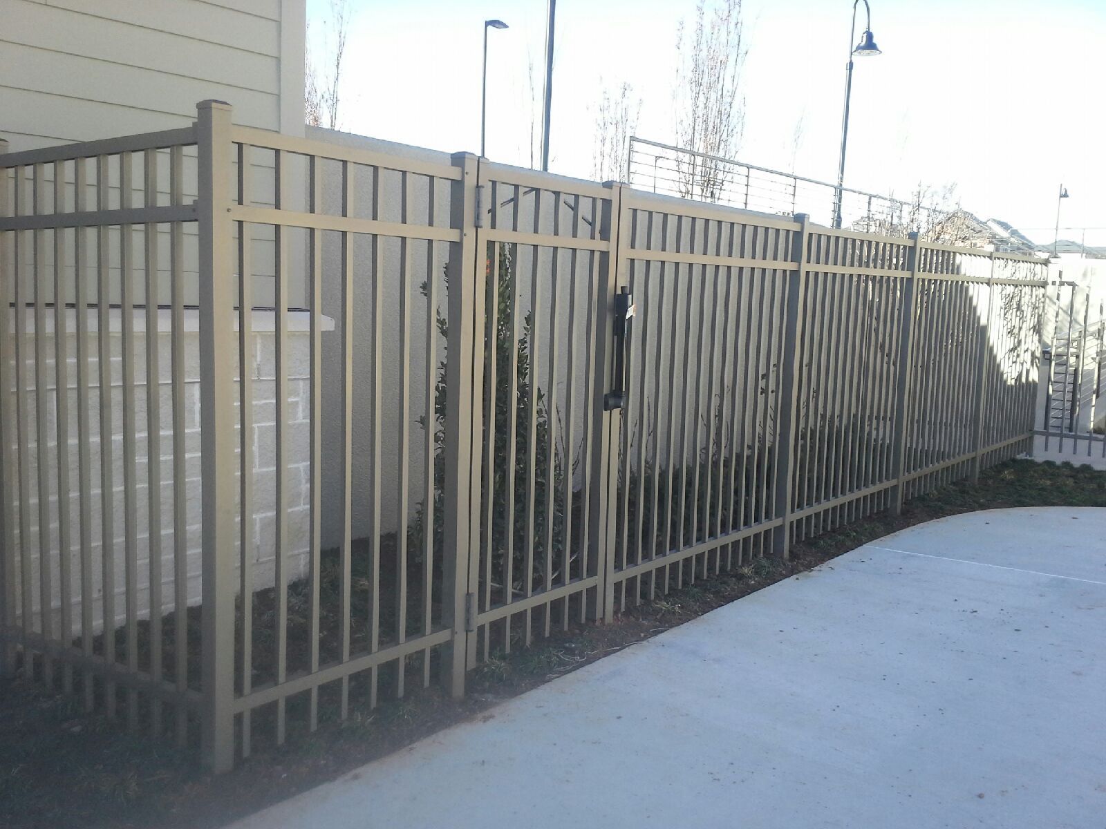 The metal fence has a metal gate.